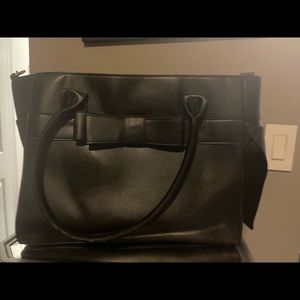 Pet carrier. Looks like a purse. Beautiful.